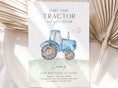 a blue tractor birthday party card on a plate