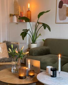 a living room filled with furniture and candles on top of it's coffee table