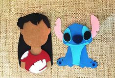 two paper cut outs depicting the faces of characters from disney's lili and stitch