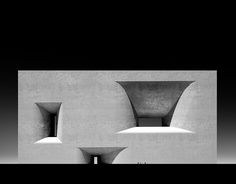 an abstract black and white photo of two concrete structures with open spaces in the middle