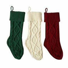 three pairs of knitted christmas stockings in different colors and patterns, one with a cabled design on the bottom