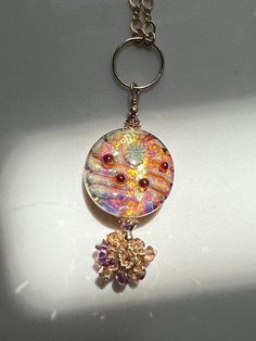 I love all things sparkly!  This pendant definitely has plenty of sparkleliciousness, is that a word?  Well, it is now!  I do not recall who made the beautiful bead with all that lovely dichroic running through it, I will continue my research!  I accented the bead with Swarovski 4 mm iris ab* and metallic sun bicone crystals and teeny tiny spacer beads.  I attached it to a gold filled ring that I then attached to the chain for the necklace.  The necklace portion measures 16 inches, the pendant, Iridescent Beaded Jewelry As A Gift, Iridescent Beaded Jewelry For Gift, Handmade Iridescent Round Jewelry, Iridescent Sparkling Round Jewelry, Sparkling Iridescent Round Jewelry, Iridescent Sparkling Jewelry As Gift, Iridescent Sparkling Jewelry Gift, Handmade Iridescent Round Bead Jewelry, Sparkling Iridescent Jewelry As Gift