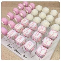 baby shower cupcakes and cake pops on a table