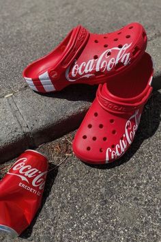 Step into happiness with these Coca-Cola themed Crocs! Whether you're running errands or lounging at home, these Crocs will keep you comfortable and stylish. With the classic red and white color scheme and iconic Coca-Cola logo, these shoes are a must-have for any Coke lover. Perfect for summer outings or cozy nights in, these Crocs are sure to become your new favorite footwear. Get yours today and add a pop of fun to any outfit! #affiliate #cocacola #soda #crocs #uniquecrocs Coca Cola Merchandise, Shoes Crocs, Beta Fish, Crocs Men, White Color Scheme, Crocs Classic Clogs