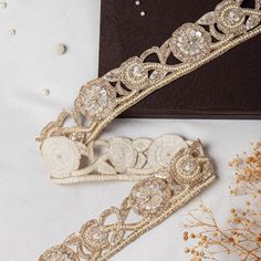 Beautiful Light Golden Zardozi Glass Bead and Pearl Floral Lace Trim | Embroidered Cut-Work Ribbon for Wedding Sash, Dress Embellishment This beautiful Lace can be used for designing stylish blouses, shrugs, skirts, tunics, festive wear, wedding wear and dresses. This stunning lace trim is great for any sewing and craft projects. A perfect embellishment for a bridal dresses or for any festive mood outfit. Our lace will add mystique to your fabric, you can use this lace alone or add it with other laces to create a new unique design for, any of your project : ➤dress border, dupattas, scarves and veils ➤jewelry making, ➤for making a DIY belt ➤designing stylish blouses, ➤waist belt to match your plain outfit ➤festive wear, wedding wear, dresses ➤Embellish your clutch purses ➤Can also be incorp Elegant Gold Embroidered Bridal Belt, Gold Embellished Embroidered Fabric For Wedding, Elegant Embroidered Bridal Belt For Wedding, Gold Embroidered Trims For Wedding, Gold Embroidered Wedding Trims, Festive Gold Embellished Bridal Belt, Gold Embellished Bridal Belt For Festive Occasion, Festive Gold Embroidered Bridal Belt, Elegant Bridal Belt For Wedding And Festive Occasions