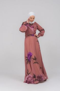 Indulge in the luxurious elegance of our Eclat chiffon flared sleeve mock v-neck maxi dress. Adorned with a bold floral pattern, this dress exudes sophistication and exclusivity. The flowing chiffon material and flared sleeves provide a delicate and sensual touch, making you feel like a work of art. Elevate your wardrobe with this premium piece. Embrace the graceful and refined style of our Eclat chiffon flared sleeve mock v-neck maxi dress. Featuring a striking floral pattern, this abaya is a t Luxury Long Sleeve Kaftan With Floral Print, Elegant Floor-length Floral Embroidered Kaftan, Elegant Floral Embroidered V-neck Kaftan, Silk Floral Print Floor-length Kaftan, Modest Activewear, Full Coverage Swimsuit, Bohemian Floor-length Floral Print Kaftan, Abaya Dress, Chiffon Material