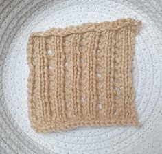 a close up of a knitted object on a white surface with circles around it