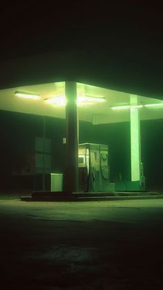 an empty gas station at night with the lights on