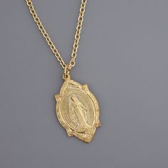 "Vintage Jewelry - Vintage Necklace - Gold Brass Mother Mary Necklace - Catholic jewelry - Chloe's Vintage Jewelry - Spiritual Jewelry - handmade jewelry This is such a beautiful vintage necklace!  Vintage gold brass with a highly detailed image of Mother Mary on the front and the heart of Mary and Jesus on the back.  Exquisite detail. The pendant hangs from a gold plated chain.  Chloe says, Wear it and feel fabulous!\" The pendant is 1 1/4\" long.  You can choose the necklace length you would l Miraculous Medal Pendant Necklace For Anniversary, Anniversary Pendant Necklace With Miraculous Medal, Mother Mary Necklace, Vintage Chloe, Jewelry Spiritual, Aquarius Necklace, Mother Mary Images, Mary Necklace, Vintage Choker Necklace