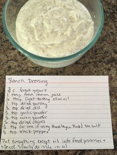 a bowl of ranch dressing next to a note