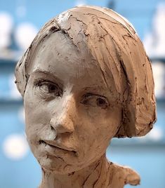 a clay sculpture of a woman's face