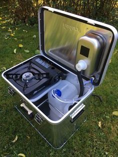 an open box with a water pump inside on the grass