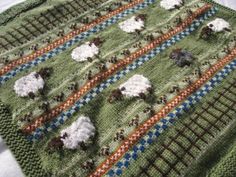 there is a crocheted blanket with sheep on it