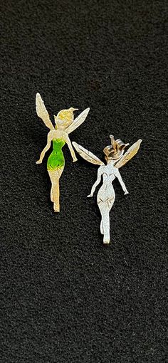 A pair of Cute Tinkerbell Earrings that are made completely out of Silver 925 (aka Sterling Silver, the earrings are stamped). These Dainty Enamel Gold Plated Tinkerbell Earrings come as a reminder of our childhood. A beautifully made fantasy world called Neverland where every man and every woman desires to be back at it again. Peter Pans Tinkerbell Stud Earrings can do that by simply wearing them. Peter Pans Mini Fairy Earrings are handmade as a reminder that we can ever get old in soul. The ea Green Fairy Earrings For Gift, Fairy Style Green Earrings For Gifts, Silver Fairy Earrings For Party, Fairy Style Silver Earrings, Silver Fairy Style Party Earrings, Tinkerbell Earrings, Cute Tinkerbell, Peter Pans, Fairy Earrings