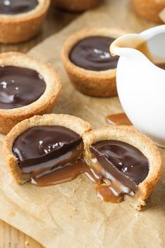 mini chocolate tarts with caramel drizzled on top and one half eaten