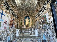 the interior of a church with mosaics on the walls and ceiling, including statues