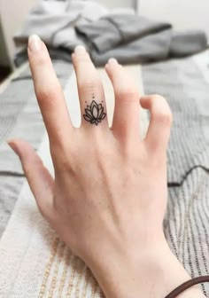 a woman's hand with a small tattoo on it