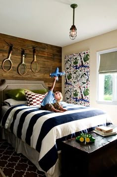 a bed room with a neatly made bed and hanging utensils