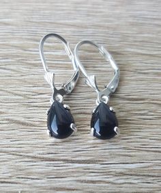 These are genuine Black Onyx teardrop shape earrings set in Sterling Silver or Gold. The prong set is handmade by me and holds the stone in securely.These Beautiful Stones are Black in color and are 9mm long and 6mm wide. The setting is hand made by me in Sterling Silver or Gold and is a strong prong setting which keeps the Onyx in securely. Lever backs keep them safely in your ears.These are a great size for any occasion. You can wear these to work, to a party or even to a wedding.I can make th Black Teardrop Jewelry With Matching Earrings, Teardrop Earrings With Lever Back Ear Wires, Black Drop Earrings For Gift, Black Teardrop Jewelry Making Supplies, Black Pear-shaped Jewelry As Gift, Black Pear-shaped Jewelry For Gift, Black Teardrop Earrings As Gift, Black Pear-shaped Jewelry Gift, Black Teardrop Ear Wire Jewelry