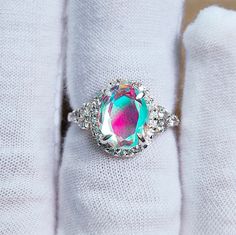 Main Stone : Mystic Opal Stone Size : 10x8 mm Stone Shape : Oval Stone color : Multi color Multi fire Metal : 925 Sterling Silver Plating : Silver / Gold / Rose Gold Side Stone : cz Setting type : Prong setting Occasion : Wedding ,Party, Anniversary, Valentine's Day, Daily Style : Classic Rings Type :Halo ring, Wedding Bands Item Type : Ring If You Have Any Questions, Please Feel Free Contact Us through Etsy Message Service If you want to make jewelry of some other design or other types please c Multicolor Oval Halo Setting Jewelry, Oval Multicolor Jewelry With Halo Setting, Multicolor Oval Jewelry With Halo Setting, Elegant Multicolor Oval Crystal Ring, Elegant Oval Rainbow Rings, Iridescent Opal Ring Oval Shaped, Iridescent Oval Opal Gemstone Ring, Iridescent Oval Crystal Ring For Gift, Iridescent Oval Rings For Gifts