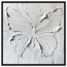 a white butterfly painted on the side of a wall