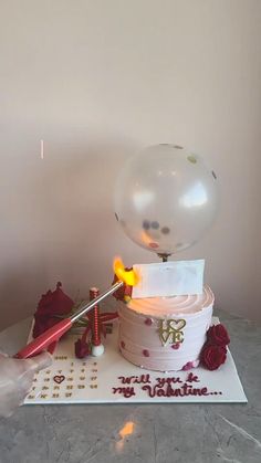 a birthday cake with a balloon on top