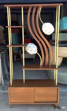 a wooden shelf with two white balls on it and some other items in the background