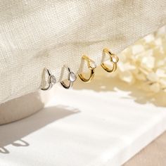 A pair of delicate Moonstone mini huggie hoop earrings in 14k yellow gold or white gold plated 925 sterling silver. These minimalist dainty earrings feature a small natural moonstone hoop.  Stack these gold moonstone earrings with -  Starburst opal hoop earrings: https://www.etsy.com/uk/listing/1341094262/genuine-opal-star-hoop-earrings-in-14k Moonstone gold necklace: https://www.etsy.com/uk/listing/1181311651/natural-moonstone-star-necklace-in-14k Moonstone gold ring: https://www.etsy.com/uk/li Dainty White Round Huggie Earrings, Dainty White Gold Hoop Earrings, Dainty Huggie Earrings For Anniversary, Everyday White Huggie Cartilage Earrings, Dainty White Sterling Silver Huggie Earrings, Dainty Tarnish-resistant Cartilage Earrings For Anniversary, Minimalist White Cartilage Earrings For Anniversary, Dainty White 14k Gold Hoop Earrings, White Tarnish Resistant Small Hoop Huggie Earrings