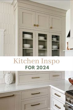 a kitchen with white cabinets and gold handles on the counter top, is featured in this article