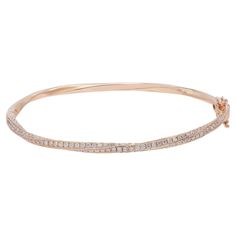 Introducing our exquisite 2.00 Carat Round Cut Diamond Twist Bangle Bracelet in Rose Gold. This captivating piece combines the elegance of a twist design with the brilliance of pave diamonds, creating a truly stunning accessory. Crafted in rose gold, it exudes a romantic and feminine allure, adding a touch of luxury to any ensemble. The centerpiece of this remarkable bracelet is the intricate twist design, adorned with meticulously arranged pave diamonds. These scintillating diamonds embellish t Luxury Round Bangle With Shiny Finish, Luxury Round Gold Ceremonial Bracelet, Luxury Round Diamond Bracelet With Intricate Design, Gold Luxury Round Cut Bracelet, Luxury Rose Gold Diamond-cut Bangle, Luxury Jeweled Round Bangle, Diamond Bangle Bracelet, Twisted Bangle, Diamond Bangles Bracelet