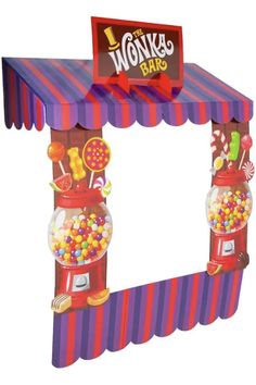 a large candy machine with lots of candies on it's sides and a sign that says wonka's bar