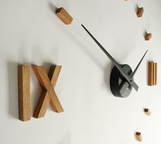 a clock made out of wood sticks and letters