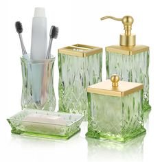 green glass bathroom accessories including toothbrushes and soap dispenser