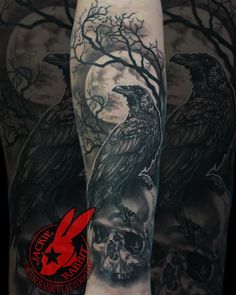 a man with a full sleeve tattoo on his arm and the image of two black crows