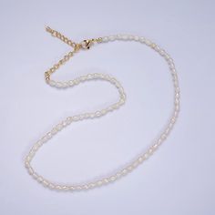 If you receive a defective item, please contact us within 5 days of arrival. Item Details - Material: Brass, gold filled, freshwater pearl Closure: Lobster claw Length: 14.2 inches with 2.0 inch extender Width: Approximately 3.2 mm Please avoid any water or chemical solutions. Keep the chain in a dry environment. Pearl White Single Strand Necklace With Round Beads, Pearl White Necklaces With Beaded Chain And Round Beads, Pearl White Necklaces With Beaded Chain, Dainty Pearl Jewelry With Spacer Beads, Pearl White Beaded Pearl Necklace, Single Strand Pearl Jewelry With Oval Beads, Pearl Necklaces With Tiny Beads For Jewelry Making, Pearl White Beaded Necklaces With Round Beads, Single Strand Pearl White Beaded Necklace