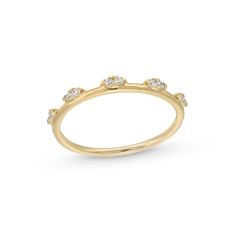 a yellow gold ring with five small diamonds