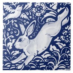 a blue and white plate with an image of a rabbit on it's side