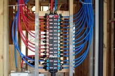 an electrical panel with multiple wires and plugs in the center, surrounded by wooden framing