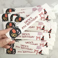 someone is holding up some birthday stickers