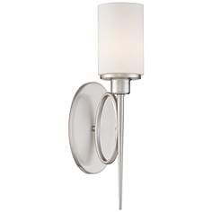 a wall light with a white shade on it