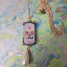 "This Upcycled Domino Has A Beautiful Newe Look... A Decoupaged Sugar Skull With Pink Swarovski Crystal Eyes, Plenty Of Sparkle And A Teardrop Pearl Bead Tassel.  This 32\" Gold Chain  Holds A Uniquely Fun Necklace.... Perfect For Your Casual Outfits Or A Great Gift For The Girl Who Loves Fun! FREE SHIPPING WITHIN THE US" White Skull Print Jewelry Gift, White Skull Print Jewelry For Gift, Domino Necklace, Domino Jewelry, Sugar Skull Necklace, Jewelry Pearl Necklace, Sugar Skull Jewelry, Pink Swarovski, Crystal Eye