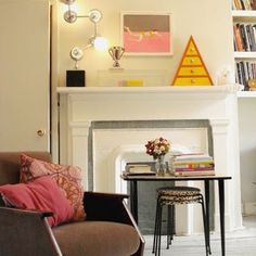 a living room filled with furniture and a fire place in front of a white fireplace