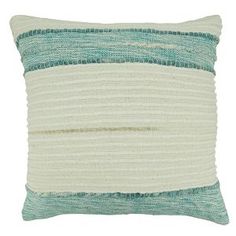 a blue and white pillow with stripes on the front, in two different shades of teal