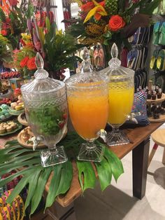 two glasses filled with orange juice sitting on top of a table