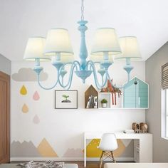 a blue chandelier hanging from the ceiling in a child's room