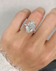 a woman's hand with a diamond ring on it