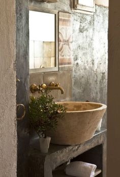 a bathroom sink sitting under a mirror next to a window