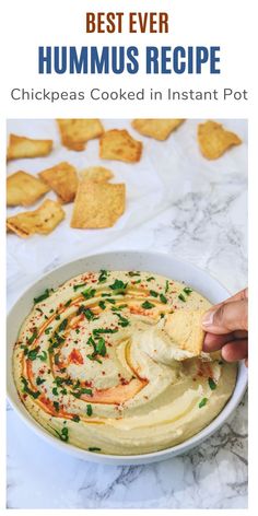 hummus recipe in a bowl with crackers on the side