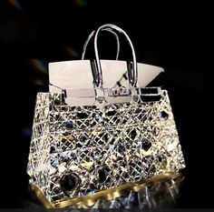 a bag that is sitting on top of a reflective surface with lights shining in the background