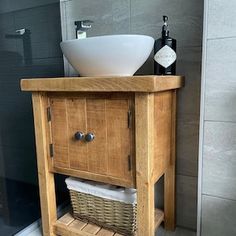 a bathroom with a sink and wooden cabinet